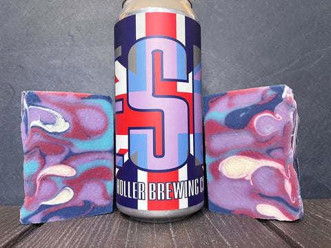 Holler Brewing Co. ESB beer can between two colorful marbled beer soap bars on a wooden surface.