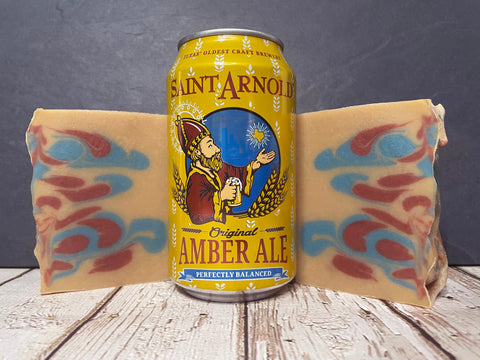Saint Arnold Amber Ale beer can between two beer soap bars on a wooden surface