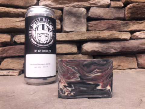 hog Molly brewing co. Beer can crowler beside a marbled beer soap bar made with activated charcoal on a stone surface