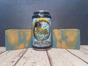 Can of double Yellow Rose beer with two pieces of Yellow Rose beer soap on a wooden surface.