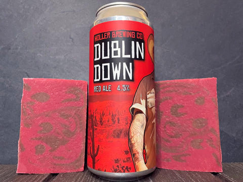 red can of Dublin down red ale from holler brewing company between two bars of brown and red swirl beer soap on a wooden surface 