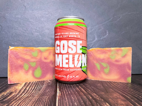 panther island brewing Gose Melon beer can between two marbled green melon and raspberry beer soaps on a wooden surface and dark background