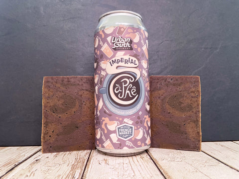 Can of Urban south brewery imperial ca phe between two bars of beer soap made with artisan coffee ground on a wooden surface with a dark stone background