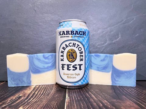 karbachtoberfest by karbach brewing company beer can between two bars of blue and white checkered karbachtoberfest beer soap on a wooden surface