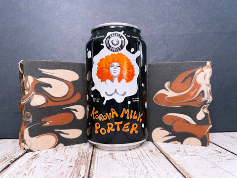 gnarly barley korova milk porter beer can between two bars chestnut cream and black beer soap made with activated charcoal on a wooden surface with dark stone background