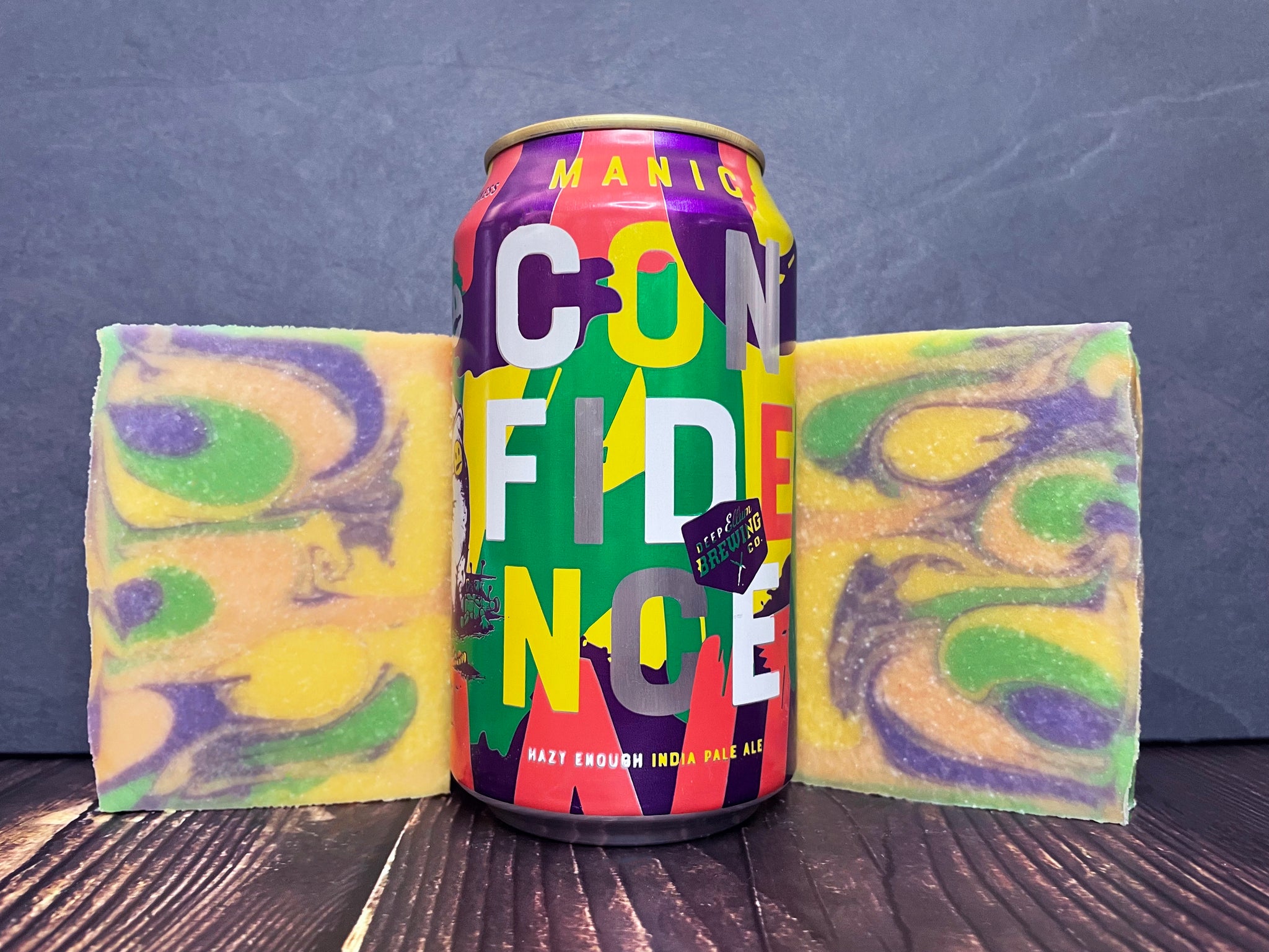 Deep Ellum Brewing Co. manic confidence beer can between two bars of ipa beer soap on a wooden surface