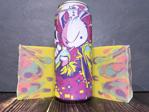 Martin house brewing company milkshake mochi beer can with anime bunny motif between two bars of yellow pink blue and purple swirl beer soap on a wooden surface