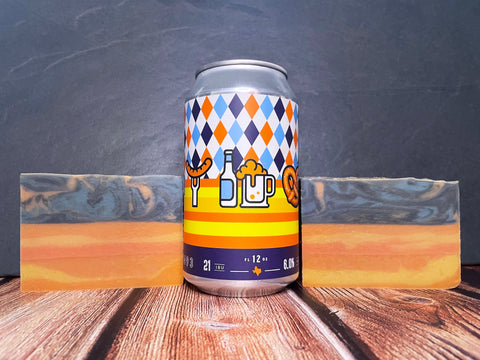 no label brewing company Oktoberfest fester Beer can with Oktoberfest themed images between two bars of Oktoberfest festbier beer soap by spunkndisorderly beer soaps 
on a wooden surface with a stone background