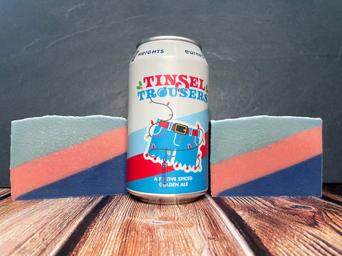 Can of eureka heights Tinsel Trousers beer between two craft beer soap bars on a wooden surface with a stone background